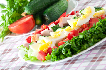 Fresh salad with chicken breast,lettuce, eggs and tomatoes 