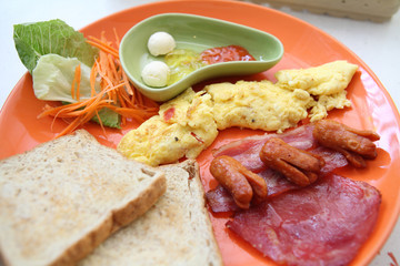 Breakfast with ham , fried egg and bread