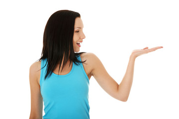 Fototapeta premium Casual woman presenting something on her heand