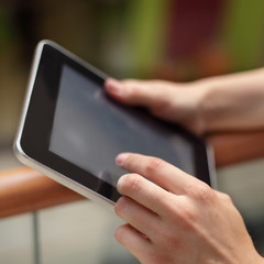 tablet computer in girl hands indoors