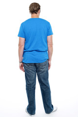 Fototapeta premium Rear view of casual young guy posing