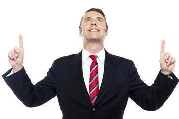 Executive looking upwards and pointing too