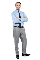 Young team leader smiling confidently with his arms crossed