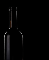 Red wine bottle silhouette over black background