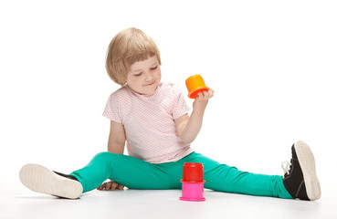 Little girl playing with toy pyramid