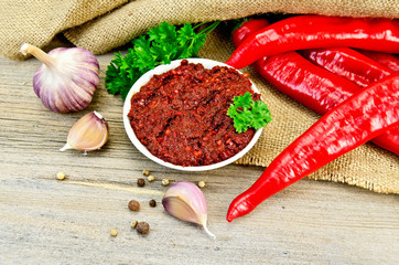 Adjika with fresh peppers on sacking