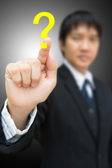 Business man pressing on Question mark