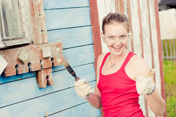 	Young woman making cosmetic alterations of house