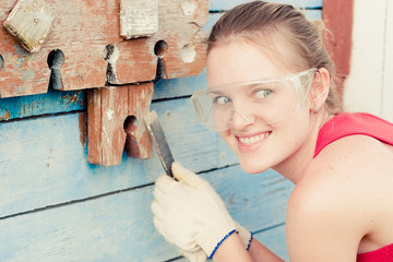 	Young woman making cosmetic alterations of house