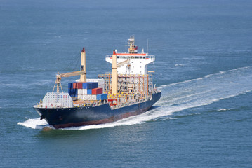 Cargo ship with containers moving