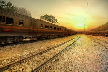 Train passing by in orange sunset