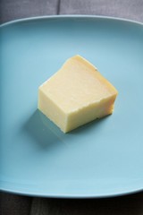 piece of cheese on blue plate