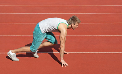 Young man preparing to run