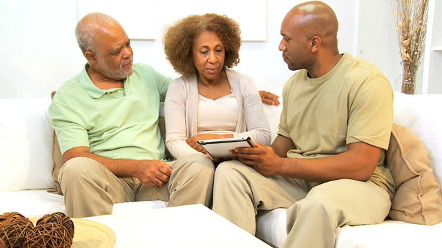 African American Son and Parents Wireless Tablet Technology