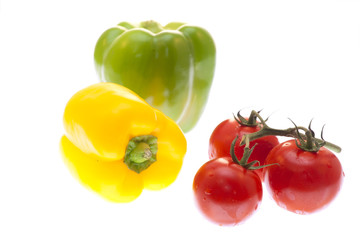 Tomatoes and peppers on white background