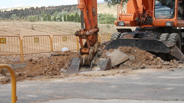 Excavator machine unloading sand at eathmoving works