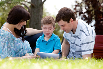 Family in Park with Digital Tablet