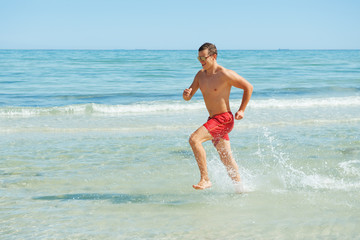 man running along the coast