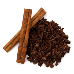 Crushed chocolate shavings pile and cinnamon sticks