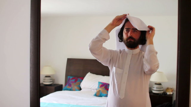 Saudi arabian man dressing at home