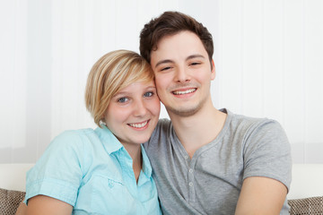 Fototapeta premium Loving couple relaxing on a sofa