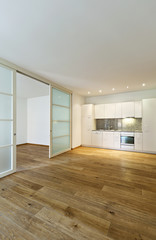 Obraz premium interior empty house with wooden floor, kitchen view