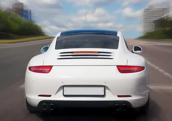 prestigious car goes on city street.