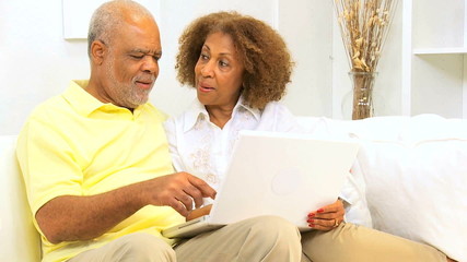 Older Ethnic Couple Laptop Computer Home