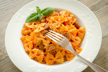 Farfalle topped with tomato sauce and meat