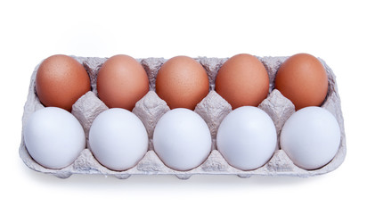 ten white and brown chicken eggs in a carton box