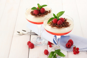 fruit jelly with berries in glasses on wooden table