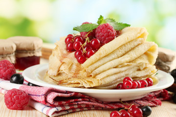 pancakes with berries, jam and honey