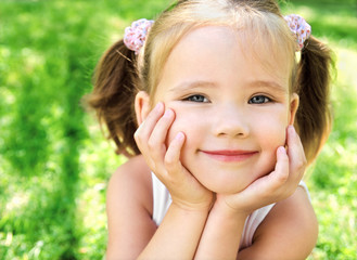 Cute little girl on the meadow
