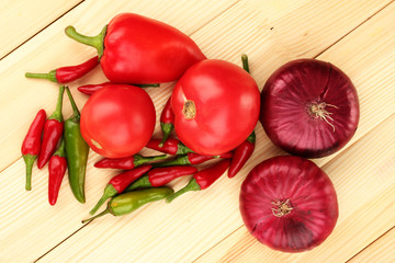 fresh red vegetables on wooden background