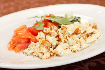 Scrambled eggs with salmon and vegetables