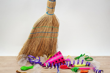 Broom sweep the trash after a party on white background © Africa Studio
