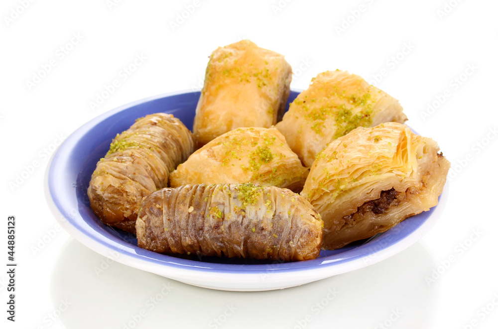 Wall mural Sweet baklava on plate isolated on white - Wall murals