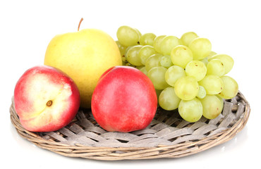ripe sweet fruits and berries on wicker mat isolated on white