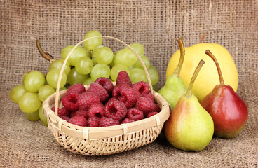 ripe sweet fruits and berries on sackcloth