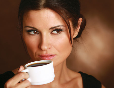 Woman with an aromatic coffee in hands