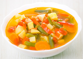Fresh vegetable soup made of green bean, carrot, potato, red bel