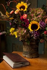 Rustic still life with autumn flowers and leather bound book