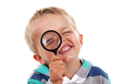 Boy searching with magnifying glass