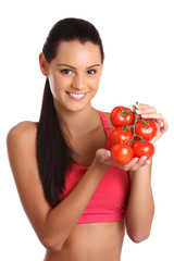 young brunette woman posing with tomatoes