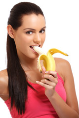 portrait of a banana eating young woman in studio