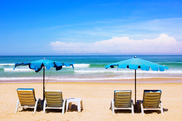 Beach chairs and with umbrella on the beach