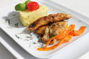 Gebratener Fisch auf dem Gemüsebett und Kartoffelpüree