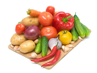 fresh vegetables on a cutting board on a white background