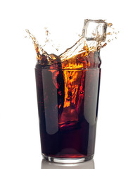 splash of cola with ice cubes