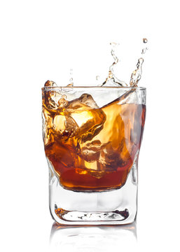 whiskey splash with ice cubes